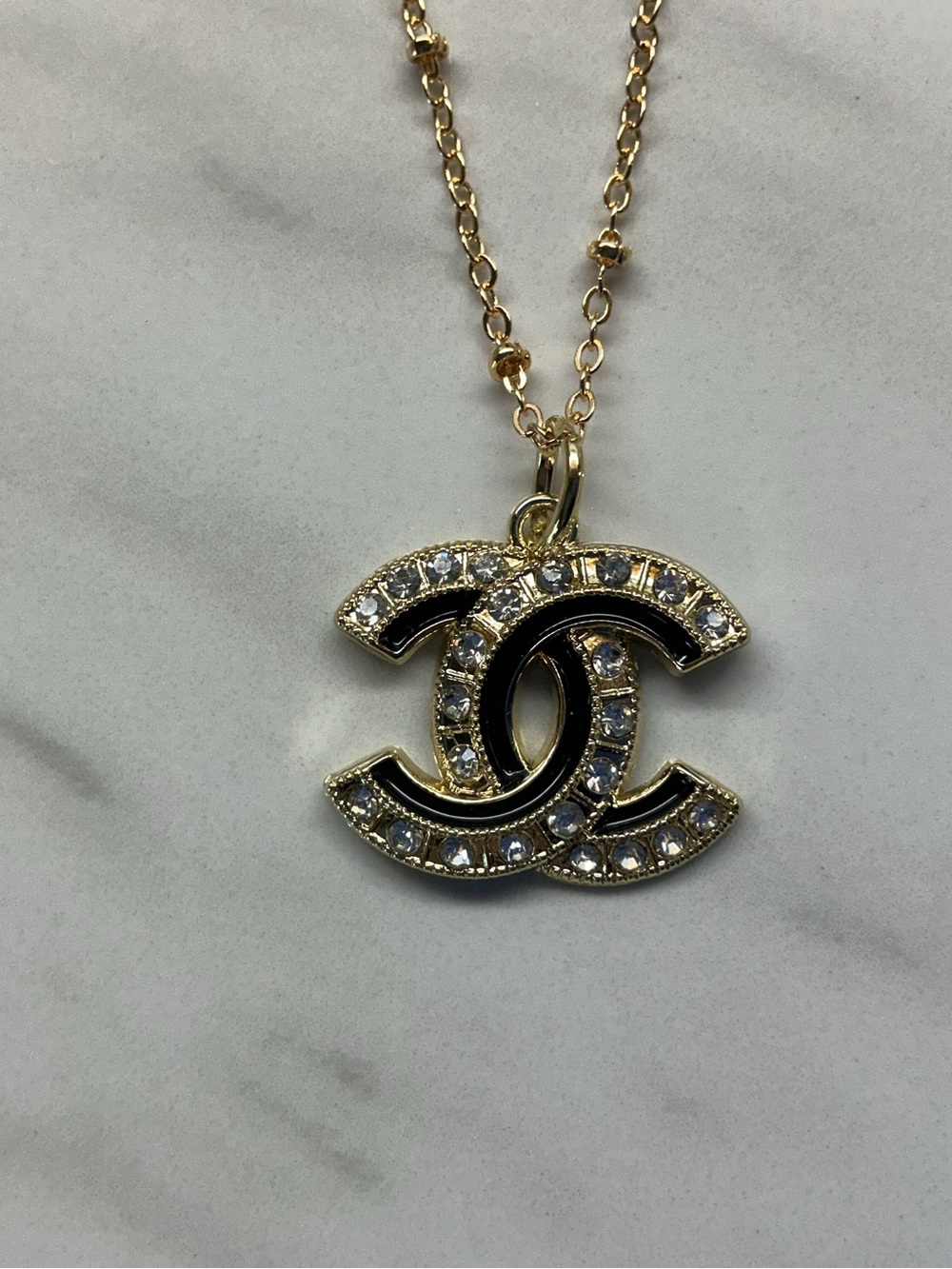 CHANEL Gold Tone CC Pendant Necklace with Black Enamel & Clear Crystals